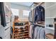Walk-in closet features custom shelving for shoes and hanging space for shirts and jackets at 412 Nickajack Retreat Ln, Smyrna, GA 30082