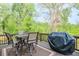 Inviting deck space with outdoor dining and grill perfect for summer entertaining in a lush setting at 412 Nickajack Retreat Ln, Smyrna, GA 30082