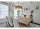 Elegant dining room with coffered ceilings, a modern chandelier, and a large table for gatherings at 412 Nickajack Retreat Ln, Smyrna, GA 30082