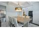 Bright dining room featuring tray ceilings, an elegant light fixture, and an expansive dining table at 412 Nickajack Retreat Ln, Smyrna, GA 30082
