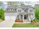 Charming two-story home featuring a landscaped yard and a two-car garage with a gray paint scheme at 412 Nickajack Retreat Ln, Smyrna, GA 30082