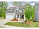 Beautiful two-story home with a manicured lawn, colorful landscaping, and a two-car garage at 412 Nickajack Retreat Ln, Smyrna, GA 30082