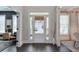 Bright foyer with dark floors, white trim, and a glass front door provides great view into the living spaces at 412 Nickajack Retreat Ln, Smyrna, GA 30082