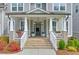 Inviting front porch with columns, seating, brick stairs, and attractive landscaping at 412 Nickajack Retreat Ln, Smyrna, GA 30082
