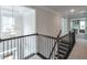 Upstairs hallway featuring decorative railing and a modern light fixture at 412 Nickajack Retreat Ln, Smyrna, GA 30082