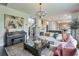 Open-concept living area with a modern piano, a large couch, and a clear view into the kitchen at 412 Nickajack Retreat Ln, Smyrna, GA 30082