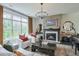 Cozy living room featuring a fireplace, a large window, and comfortable seating arrangement in neutral tones at 412 Nickajack Retreat Ln, Smyrna, GA 30082