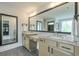 Bright bathroom features a double sink vanity with granite countertop, large mirror and tile floor at 412 Nickajack Retreat Ln, Smyrna, GA 30082