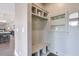 Hallway mudroom features storage bench, coat hooks, shelves, open access to the kitchen, and a mirror at 412 Nickajack Retreat Ln, Smyrna, GA 30082