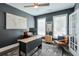 Stylish office with dark walls, a statement rug, a wooden desk and a comfortable leather chair at 412 Nickajack Retreat Ln, Smyrna, GA 30082