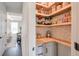 Organized pantry with custom shelving, countertop, and stylish wallpaper at 412 Nickajack Retreat Ln, Smyrna, GA 30082