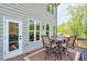 Outdoor patio showcases a dining set and peaceful setting with lush greenery at 412 Nickajack Retreat Ln, Smyrna, GA 30082