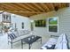 Inviting covered patio features a cozy seating area and an outdoor television at 412 Nickajack Retreat Ln, Smyrna, GA 30082
