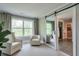 Sitting area with white armchairs next to windows, with a sliding barn door entrance to the en-suite at 412 Nickajack Retreat Ln, Smyrna, GA 30082