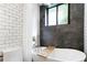 Bathroom featuring a modern tub, shower, white subway tiles, and dark accent wall at 880 Glendale Ne Ter # 9, Atlanta, GA 30308