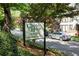 Community sign with trees, landscaping, and street view at 880 Glendale Ne Ter # 9, Atlanta, GA 30308