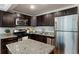 Charming kitchen features granite countertops, stainless appliances, and dark wood cabinets at 880 Glendale Ne Ter # 9, Atlanta, GA 30308