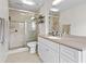 Bright bathroom with a glass shower, a large vanity, and neutral tile flooring, offering a clean space at 1 James River Ne Pl, Atlanta, GA 30342