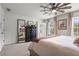 Bedroom with a comfortable bed, dresser, mirror, and natural light, creating a relaxing ambiance at 1 James River Ne Pl, Atlanta, GA 30342