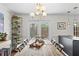 Bright dining room features a rustic wooden table, modern lighting, and an open view to the patio at 1 James River Ne Pl, Atlanta, GA 30342