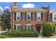 Charming two-story brick townhome featuring black shutters and manicured landscaping at 1 James River Ne Pl, Atlanta, GA 30342