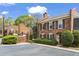 Traditional brick two-story townhome featuring black shutters, lush landscaping, and a private entrance at 1 James River Ne Pl, Atlanta, GA 30342