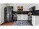 Updated kitchen with stainless steel appliances, granite counters, and decorative backsplash and shelving at 1 James River Ne Pl, Atlanta, GA 30342
