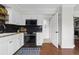 Well-lit kitchen featuring modern appliances, white cabinetry, and an adjacent pantry for ample storage at 1 James River Ne Pl, Atlanta, GA 30342