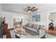 Inviting living room with hardwood floors, a decorative ceiling fan, and open dining space at 1 James River Ne Pl, Atlanta, GA 30342