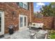 A private brick patio features seating for relaxing and dining al fresco at 1 James River Ne Pl, Atlanta, GA 30342