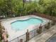 Community pool surrounded by a brick fence, greenery and brick columns at 1 James River Ne Pl, Atlanta, GA 30342