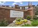 The Rosewood Plantation community sign amid colorful flowers and green grass at 1 James River Ne Pl, Atlanta, GA 30342