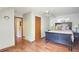 Comfortable bedroom featuring light gray walls, wooden floors, and neutral decor at 1200 Izod Ct, Lawrenceville, GA 30044