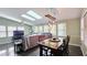 Bright breakfast nook featuring a rustic wood table, modern lighting, and multiple windows at 1200 Izod Ct, Lawrenceville, GA 30044