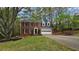 Charming two-story brick home featuring a well-manicured lawn, attached garage, and mature trees at 1200 Izod Ct, Lawrenceville, GA 30044