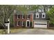 Traditional brick home with manicured landscaping, and attached garage at 1200 Izod Ct, Lawrenceville, GA 30044