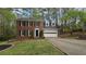 Traditional brick home with manicured landscaping, and attached garage at 1200 Izod Ct, Lawrenceville, GA 30044