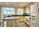 Well-lit kitchen featuring an island, white appliances, countertops and light colored cabinets at 1200 Izod Ct, Lawrenceville, GA 30044