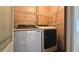 Laundry area featuring Samsung front-loading washer and dryer with wire shelving at 1200 Izod Ct, Lawrenceville, GA 30044