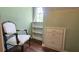 A serene room with a decorative chair, built in shelving, and a sunlit window for cozy relaxation at 1200 Izod Ct, Lawrenceville, GA 30044