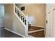 Carpeted stairway with white banister and dark hardwood steps, leading to the upper level at 1200 Izod Ct, Lawrenceville, GA 30044