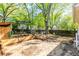 Backyard featuring a wooden storage shed, seating area, and a privacy fence with mature trees in background at 1326 Metropolitan Se Ave, Atlanta, GA 30316