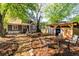 Backyard with a wooden storage shed, green trees, lush landscaping, and a relaxing seating area at 1326 Metropolitan Se Ave, Atlanta, GA 30316