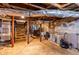 Unfinished basement with exposed beams, stone foundation, and utility sink at 1326 Metropolitan Se Ave, Atlanta, GA 30316