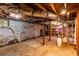 Unfinished basement featuring concrete flooring, stone walls, exposed beams and duct work at 1326 Metropolitan Se Ave, Atlanta, GA 30316