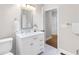Bathroom featuring single vanity with marble countertop, white cabinetry, toilet, and marble tiled floors at 1326 Metropolitan Se Ave, Atlanta, GA 30316