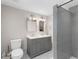 Full bathroom featuring grey vanity, double sinks, and glass door shower at 1326 Metropolitan Se Ave, Atlanta, GA 30316