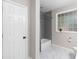 Modern bathroom featuring marble floors, gray tile and a decorative glass block window at 1326 Metropolitan Se Ave, Atlanta, GA 30316