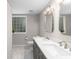 Modern bathroom with double vanity, sleek fixtures, and elegant tile flooring at 1326 Metropolitan Se Ave, Atlanta, GA 30316