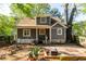 Exterior view of a charming home featuring a porch, mature trees, and well-maintained landscaping at 1326 Metropolitan Se Ave, Atlanta, GA 30316